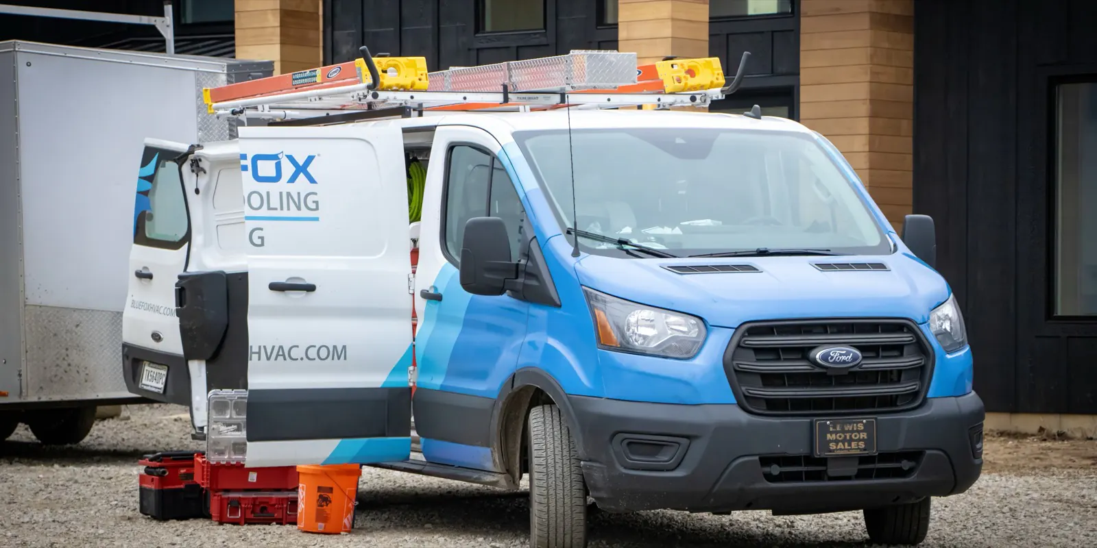 Blue Fox Heating, Cooling & Plumbing service van on a job site