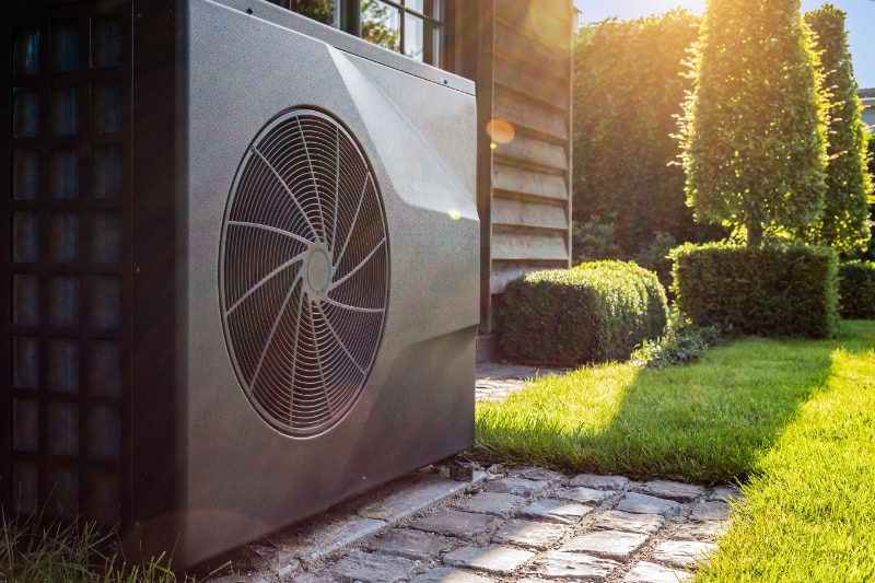 Heat pump outside next to a home.