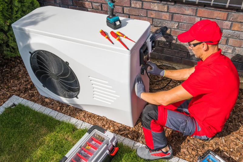 Technician working on heat pump.